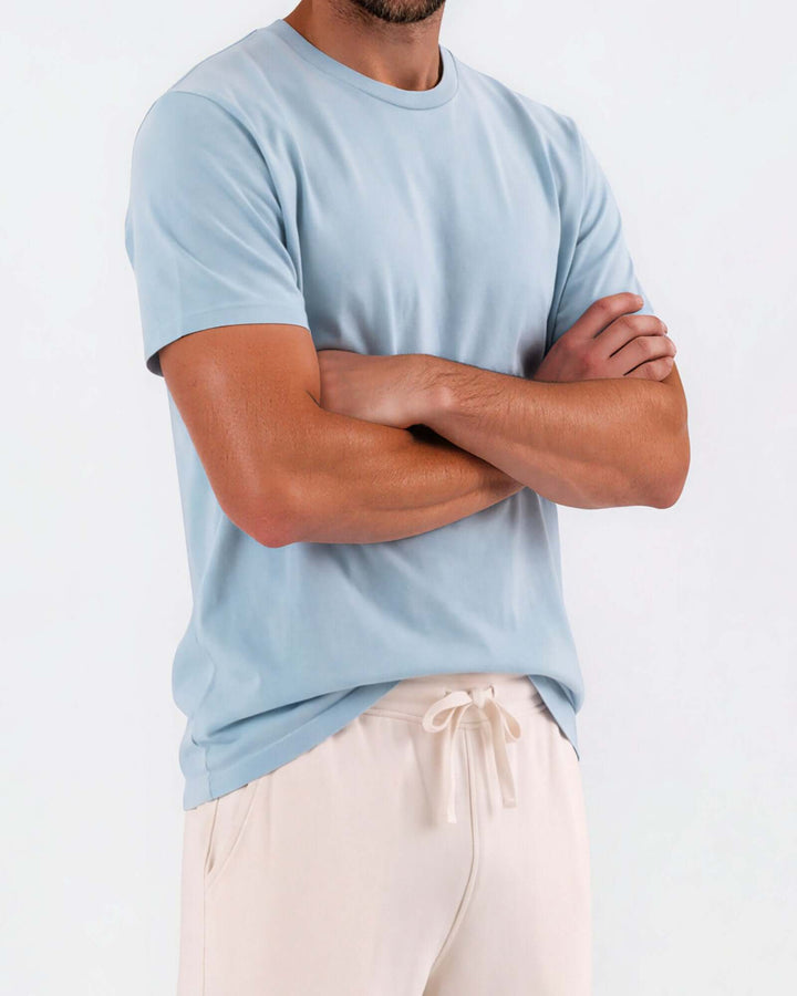 Made in USA Vintage Pigment Dyed Softest Tee - Bluestone: close-up of light blue tee on model with arms crossed