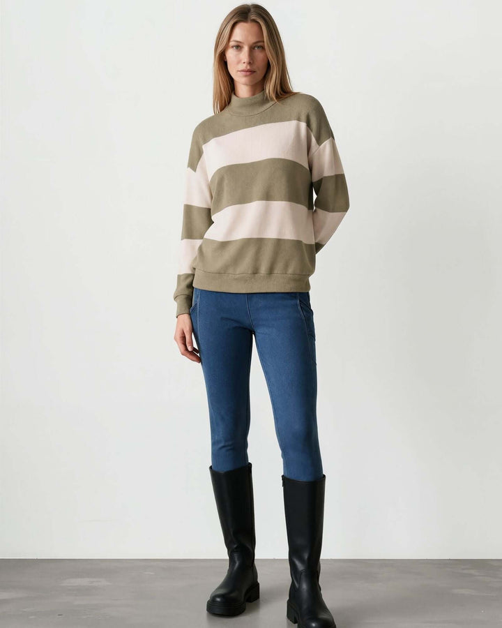 Woman wearing Made in USA olive and cream striped mock neck sweater with a relaxed fit, soft stretch knit fabric, long sleeves, and ribbed trim.