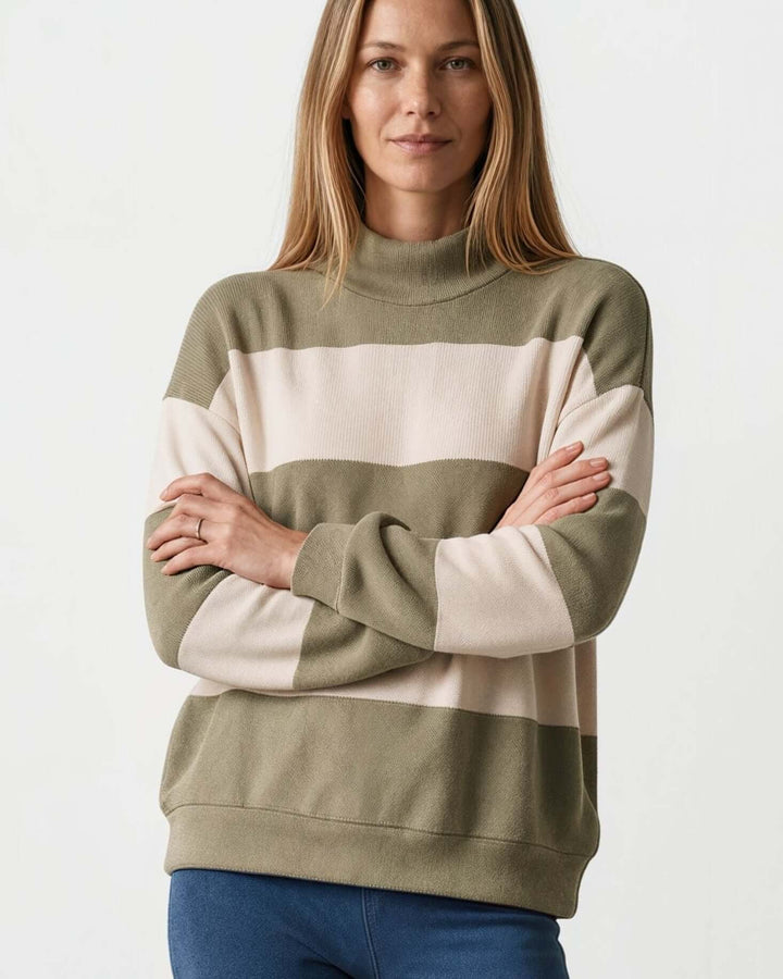 Woman wearing Made in USA olive and cream striped mock neck sweater with a relaxed fit, soft stretch knit fabric, long sleeves, and ribbed trim.