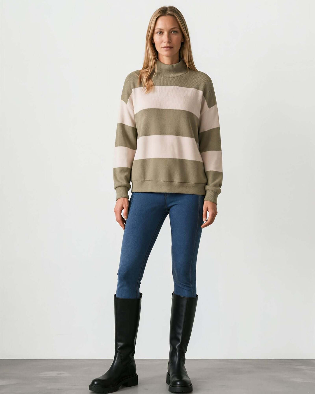 Woman wearing Made in USA olive and cream striped mock neck sweater with a relaxed fit, soft stretch knit fabric, long sleeves, and ribbed trim.