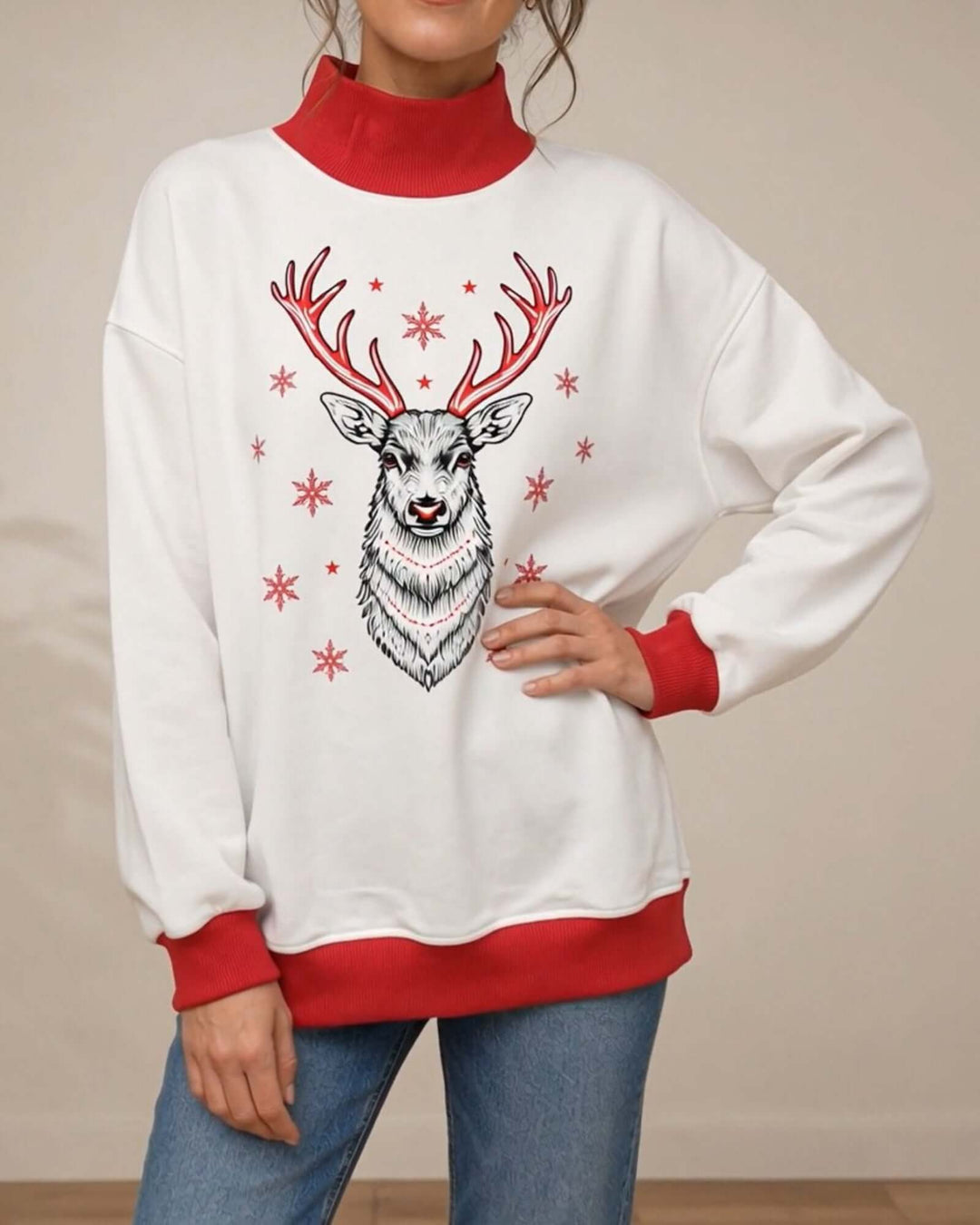 Women's white oversized mock neck sweatshirt with red ribbed trim featuring the Red Reindeer Holiday Graphic design, front view, hand on hip, Made in USA