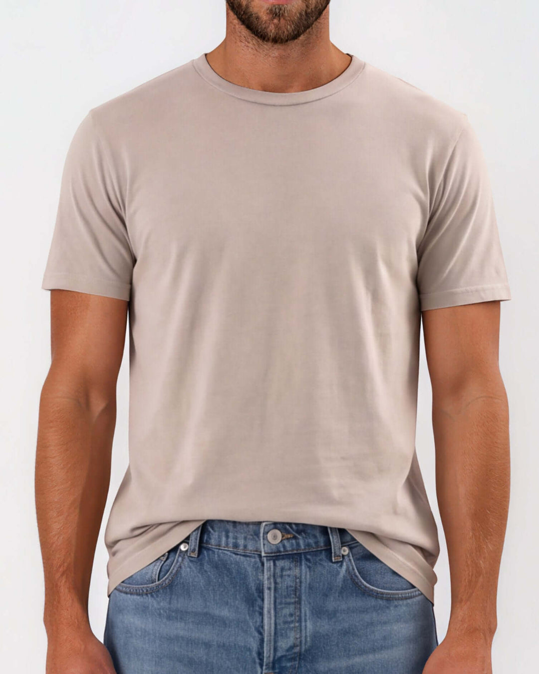 Made in USA Men's Vintage Pigment Dyed Softest Tee - Khaki: close-up front view of light khaki crew neck tee tucked over jeans