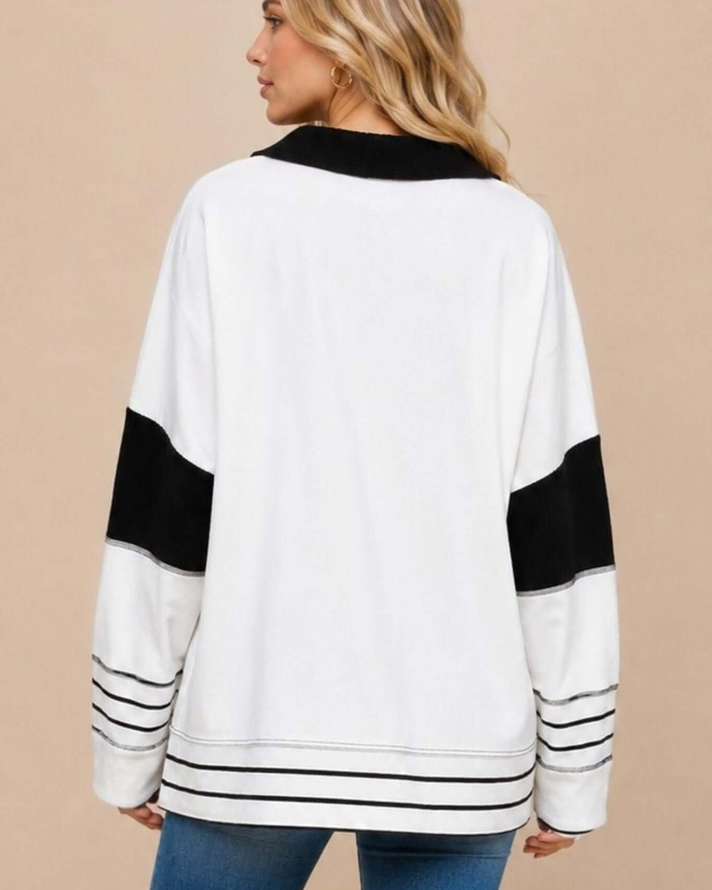 Made in USA women's white oversized French terry long sleeve top with black contrast panels, striped split collar, and striped trim, back view