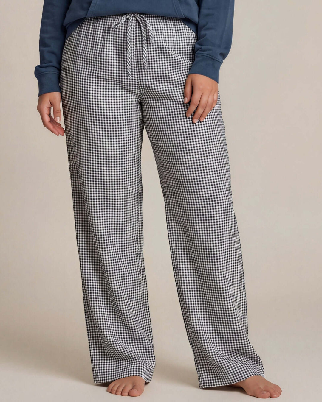 Made in USA women's plus size navy and white gingham straight-leg pajama pants with elastic waist and drawstring tie, close-up front view
