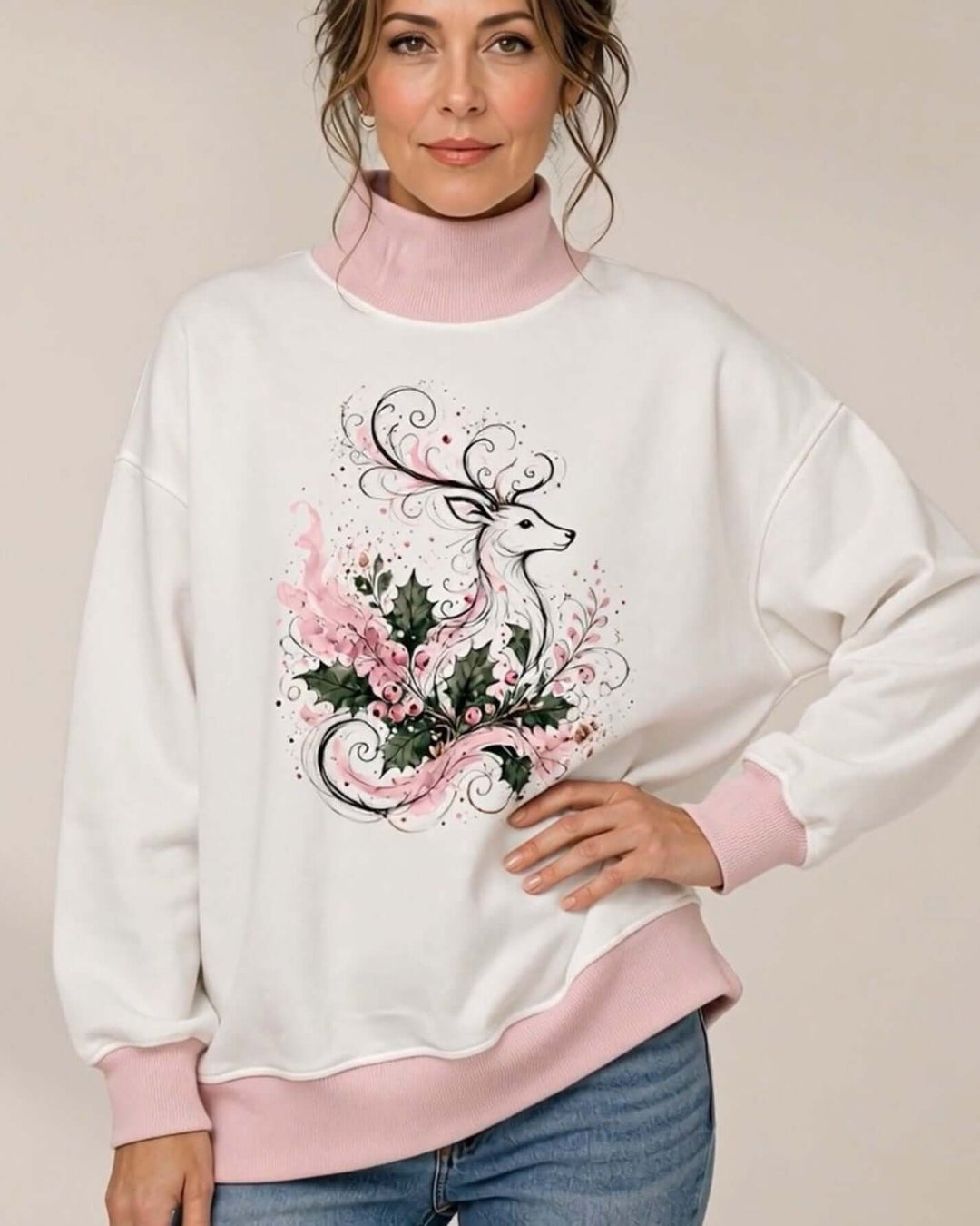 Women's white oversized mock neck sweatshirt with pink ribbed trim featuring the Whimsical Reindeer Holiday Graphic design, front view, hand on hip, Made in USA