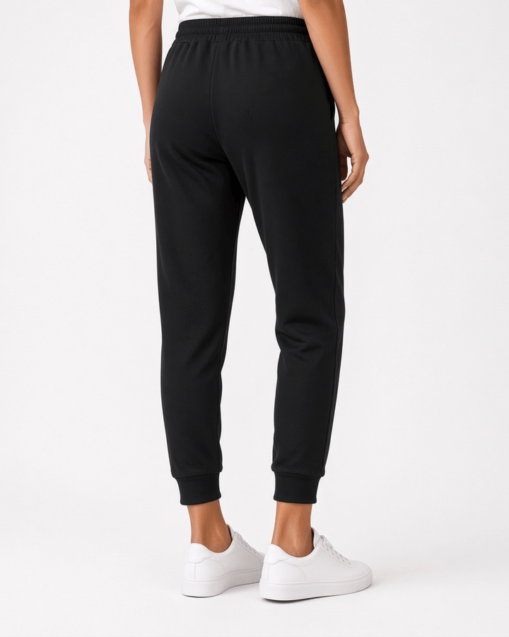 Made in USA, these black cropped joggers blend 62% cotton and 38% polyester, with a relaxed fit, pockets, and cuffed hems. Sizes S–L.