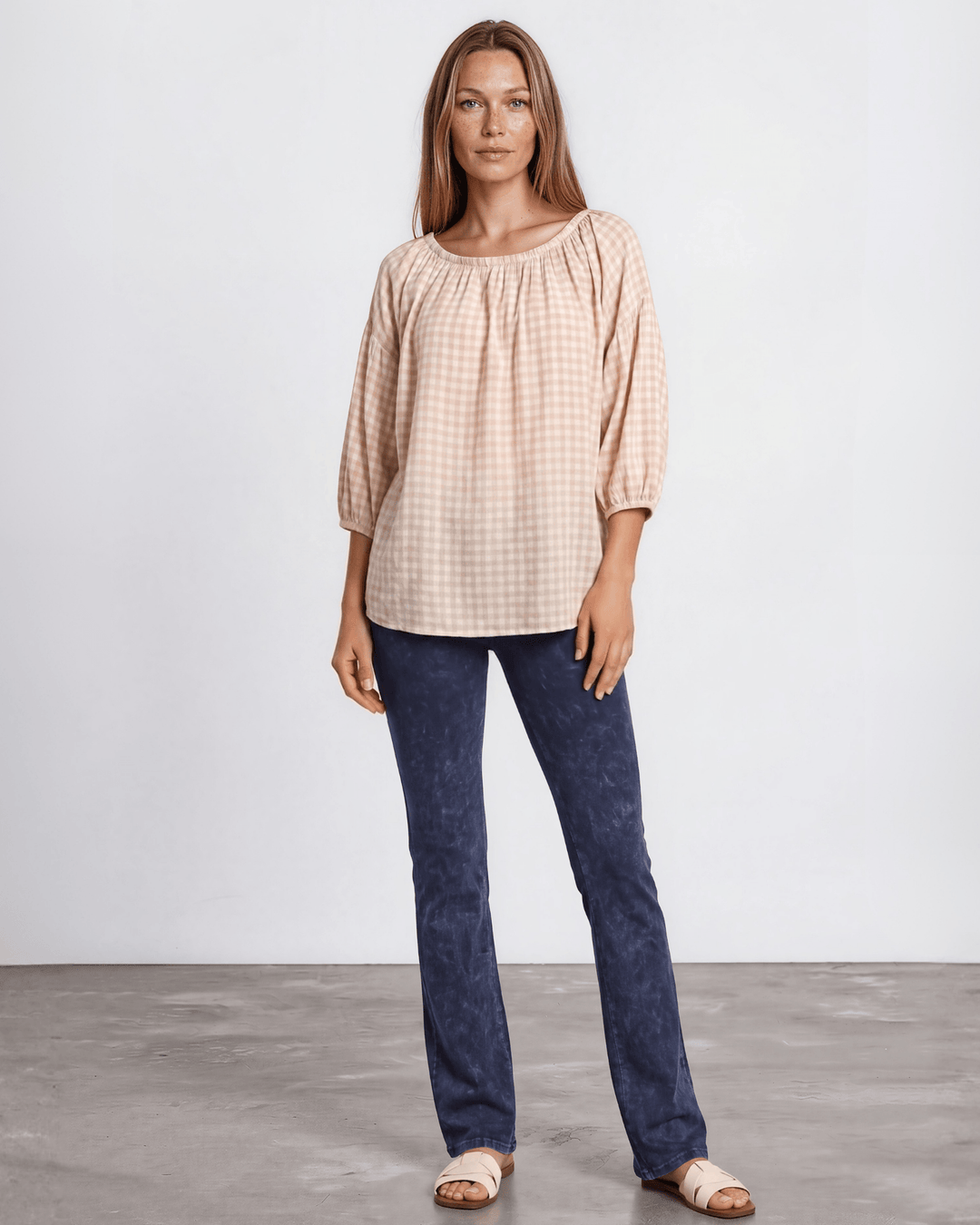 Rose gingham plaid woven peasant blouse with a stretchy elastic scoop neckline, 3/4 length puff sleeves with elasticized cuffs, and a relaxed flowy silhouette in 100% rayon. Made in USA