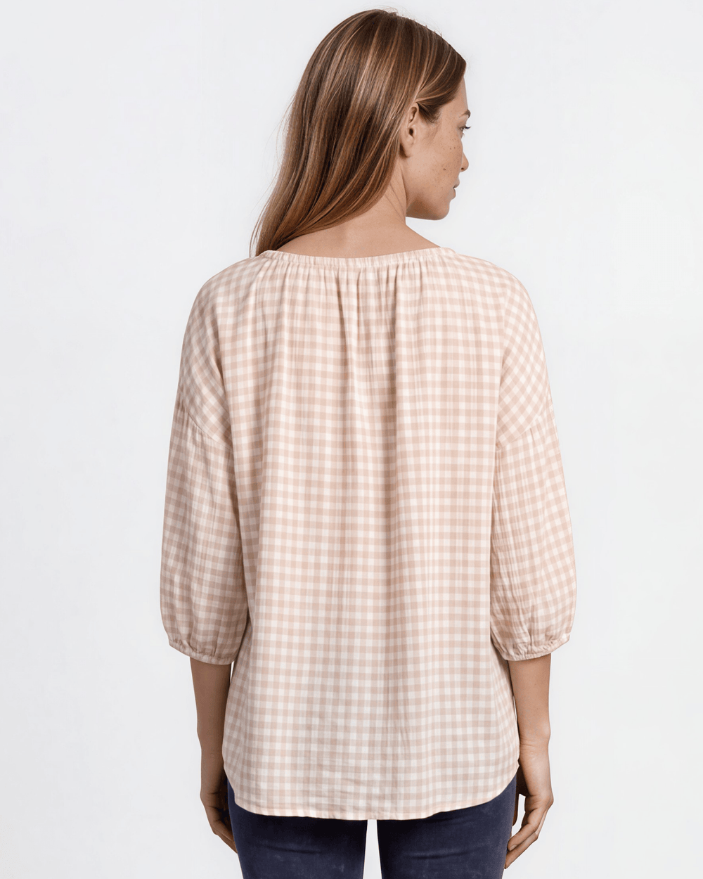 Rose gingham plaid woven peasant blouse with a stretchy elastic scoop neckline, 3/4 length puff sleeves with elasticized cuffs, and a relaxed flowy silhouette in 100% rayon. Made in USA