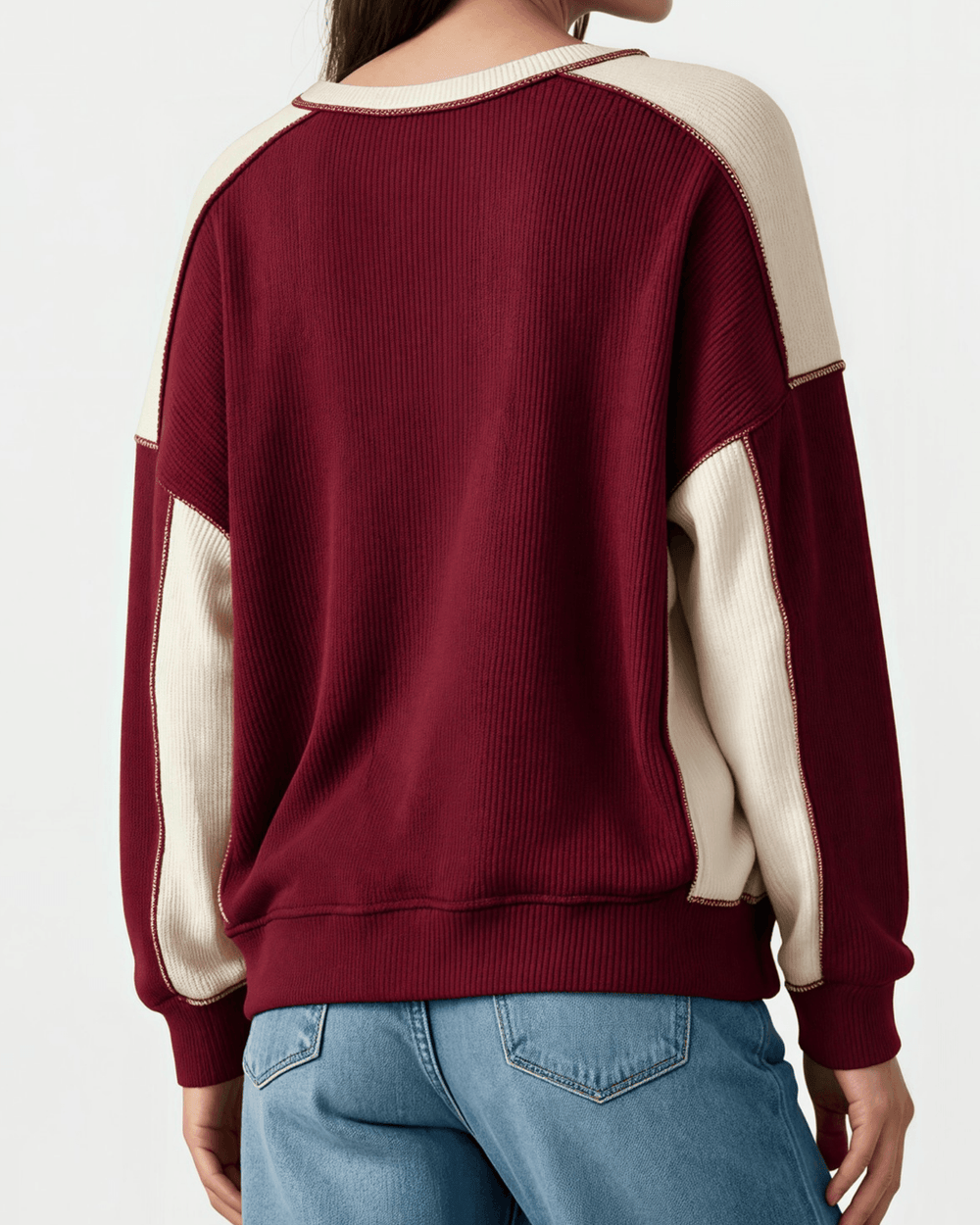 Made in USA. Burgundy & cream color block ribbed knit sweatshirt. Notched neck, exposed seams, oversized fit. 97% polyester. Sizes S–XL.