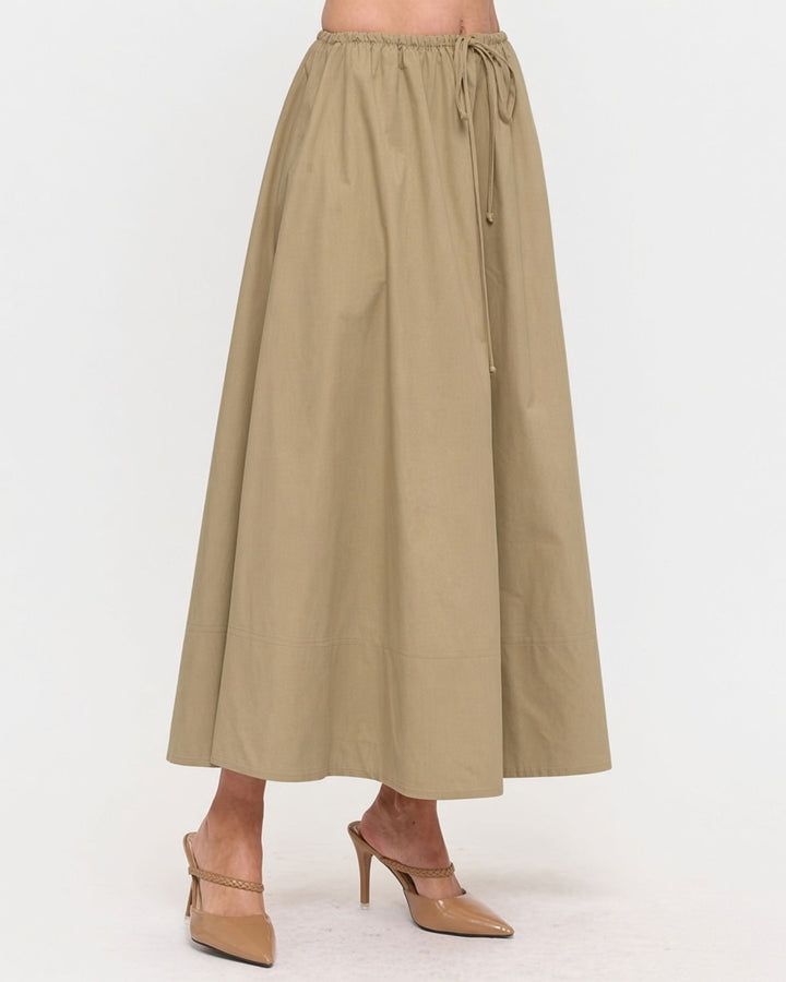 Made in USA. Discover a khaki 100% cotton poplin maxi skirt with a gathered drawstring waist and graceful, flowy silhouette. Sizes S–L.