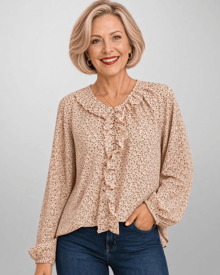 Made in USA. Renee cream botanical print blouse with a ruffled V-neck, balloon sleeves and bubble hem. Lightweight woven style for casual or dressy days.