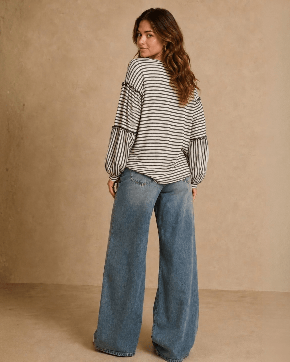 Made in USA. Tori textured striped top features stretch knit, tiered bubble sleeves and delicate ruffle trim. An easy everyday style in regular and plus sizes.