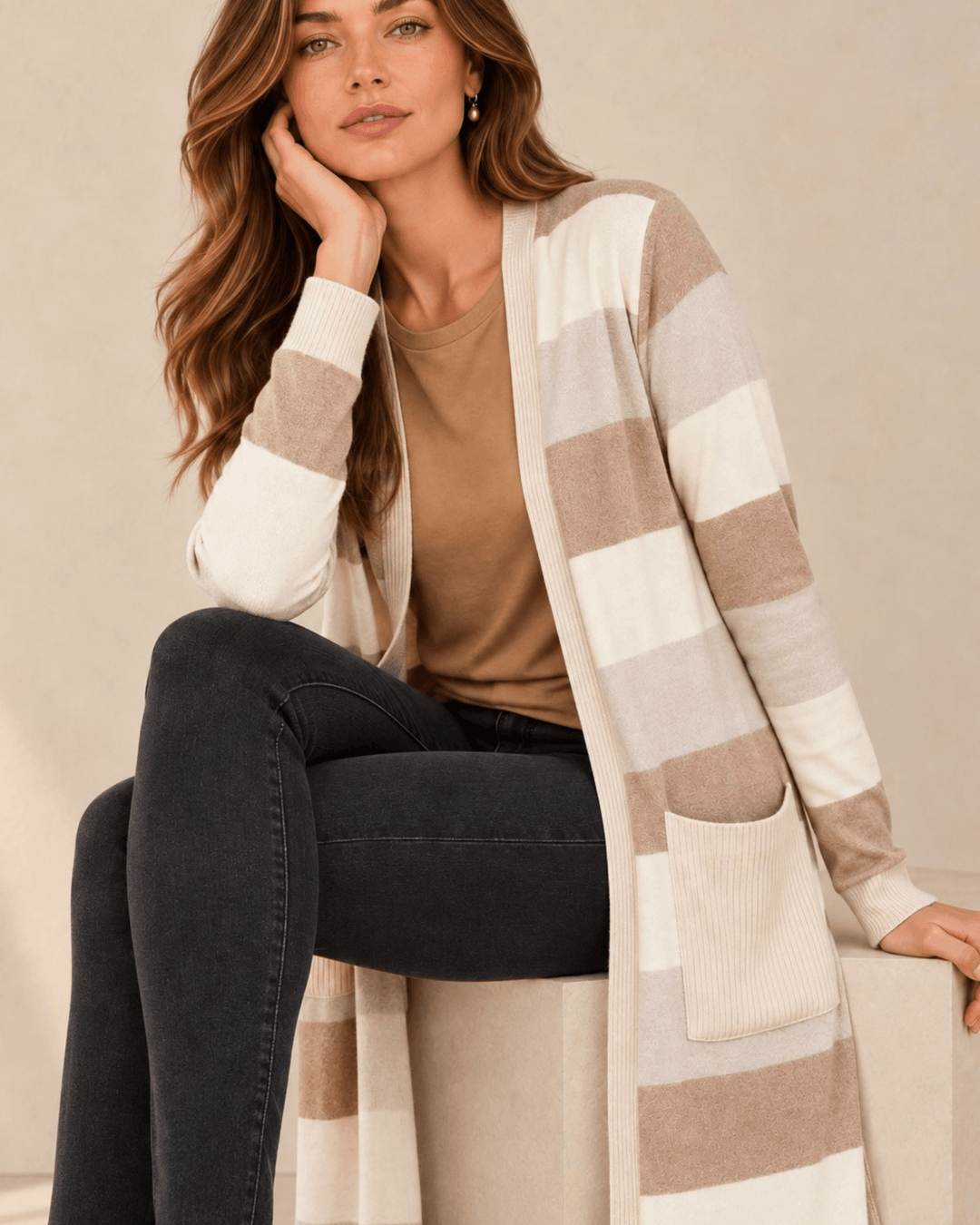 Woman wearing Made in USA the Lilian taupe striped longline cardigan with an open front, long sleeves, patch pockets and side slits for easy everyday layering.