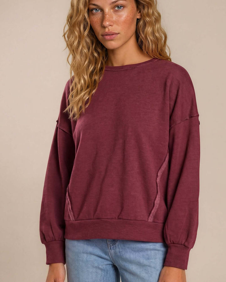 Made in USA cotton-wash pullover with an oversized boxy fit and two-tone raw-edge details. Shop the easygoing Wine or Mocha sweatshirt in S–XL.