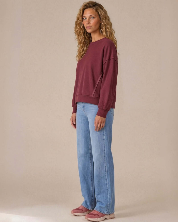 Made in USA cotton-wash pullover with an oversized boxy fit and two-tone raw-edge details. Shop the easygoing Wine or Mocha sweatshirt in S–XL.
