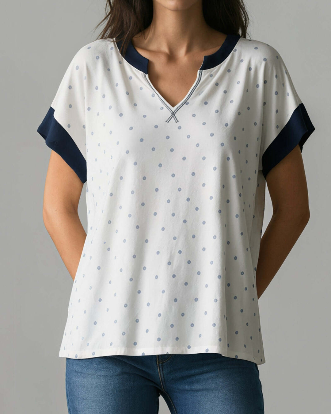Made in USA women's white and navy polka dot split V-neck short sleeve top with navy contrast trim, front view