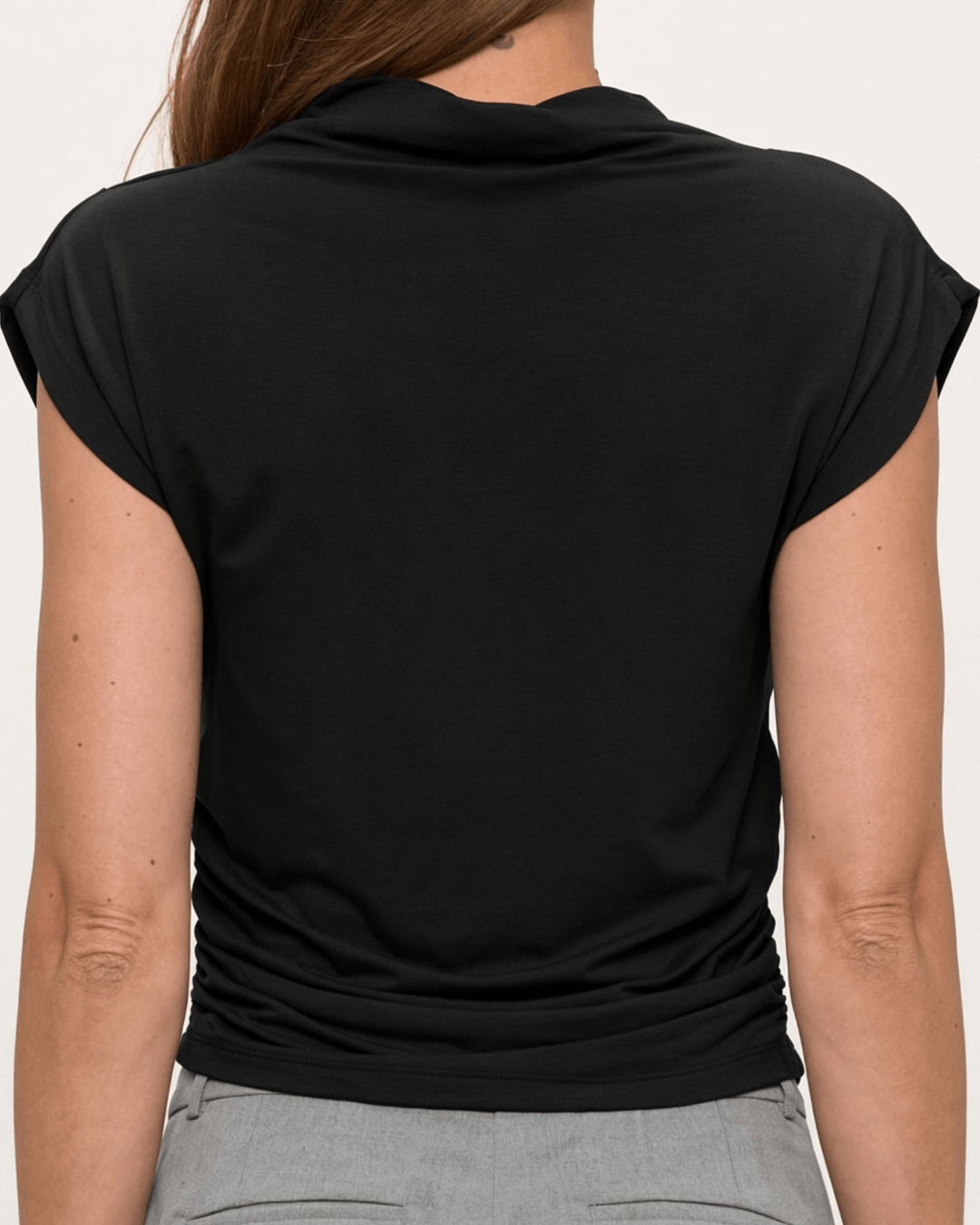 Woman wearing, made in USA, the Missy mock neck top pairs soft modal stretch with flattering side ruching. Shop this fitted short-sleeve style in Black.
