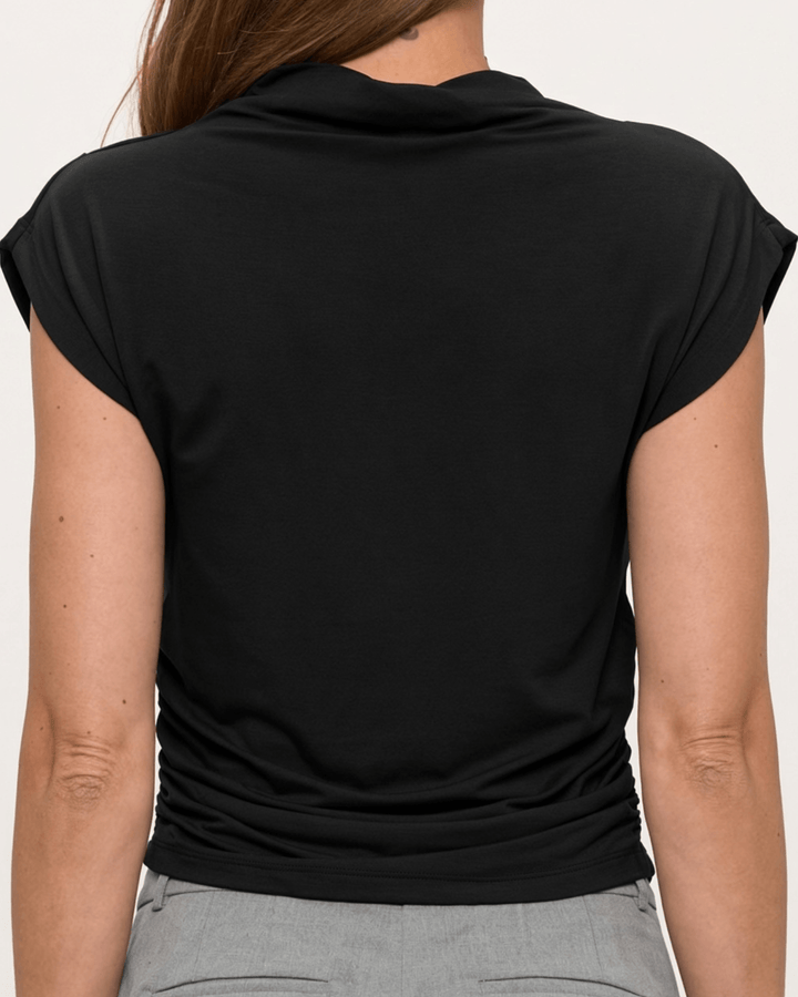 Woman wearing, made in USA, the Missy mock neck top pairs soft modal stretch with flattering side ruching. Shop this fitted short-sleeve style in Black.