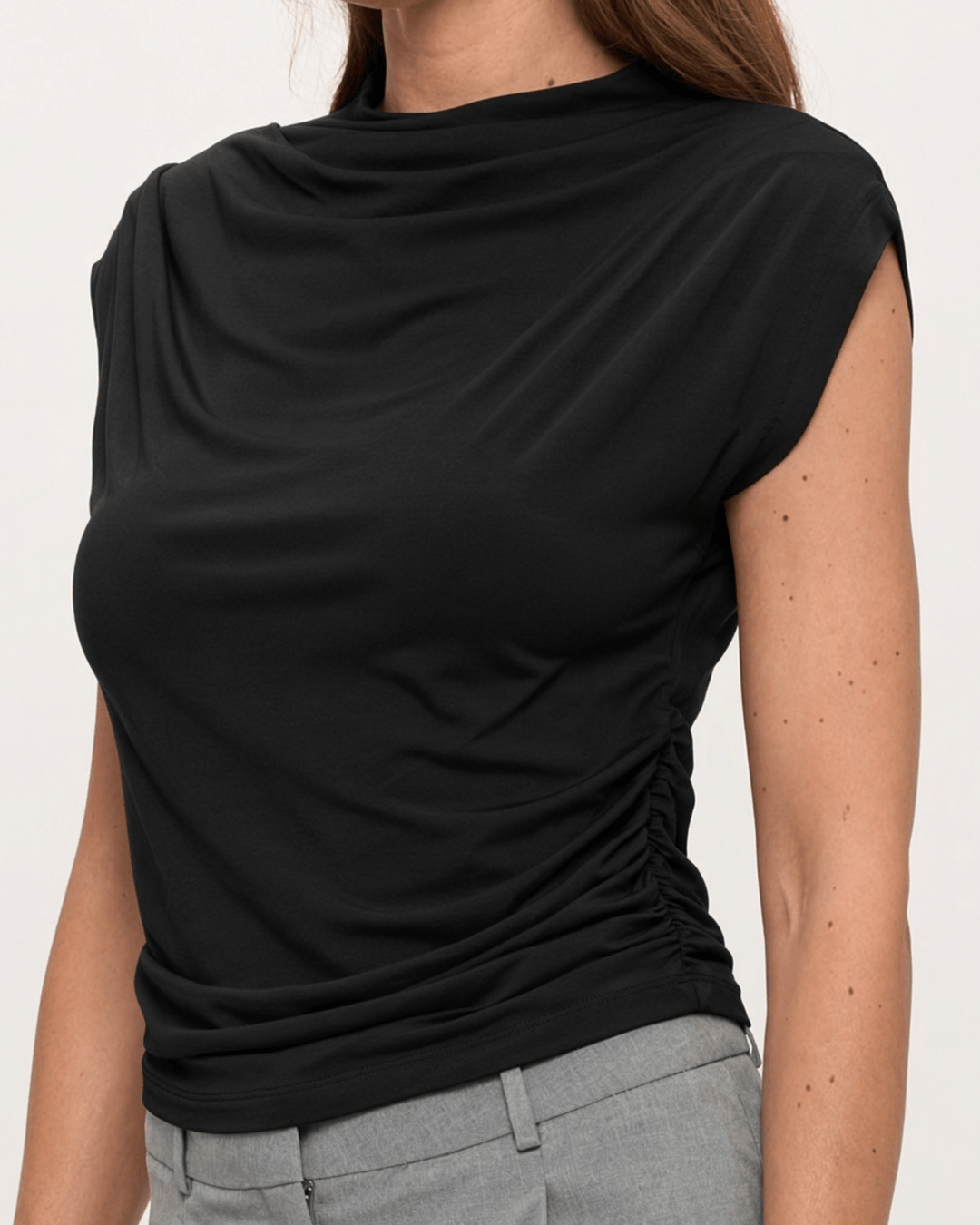 Woman wearing, made in USA, the Missy mock neck top pairs soft modal stretch with flattering side ruching. Shop this fitted short-sleeve style in Black.