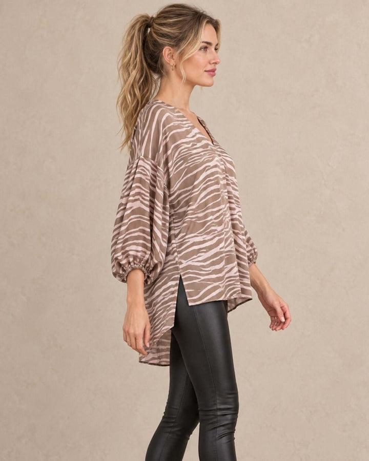 Made in USA taupe and cream zebra print blouse with V neckline, bubble sleeves, and high-low hem