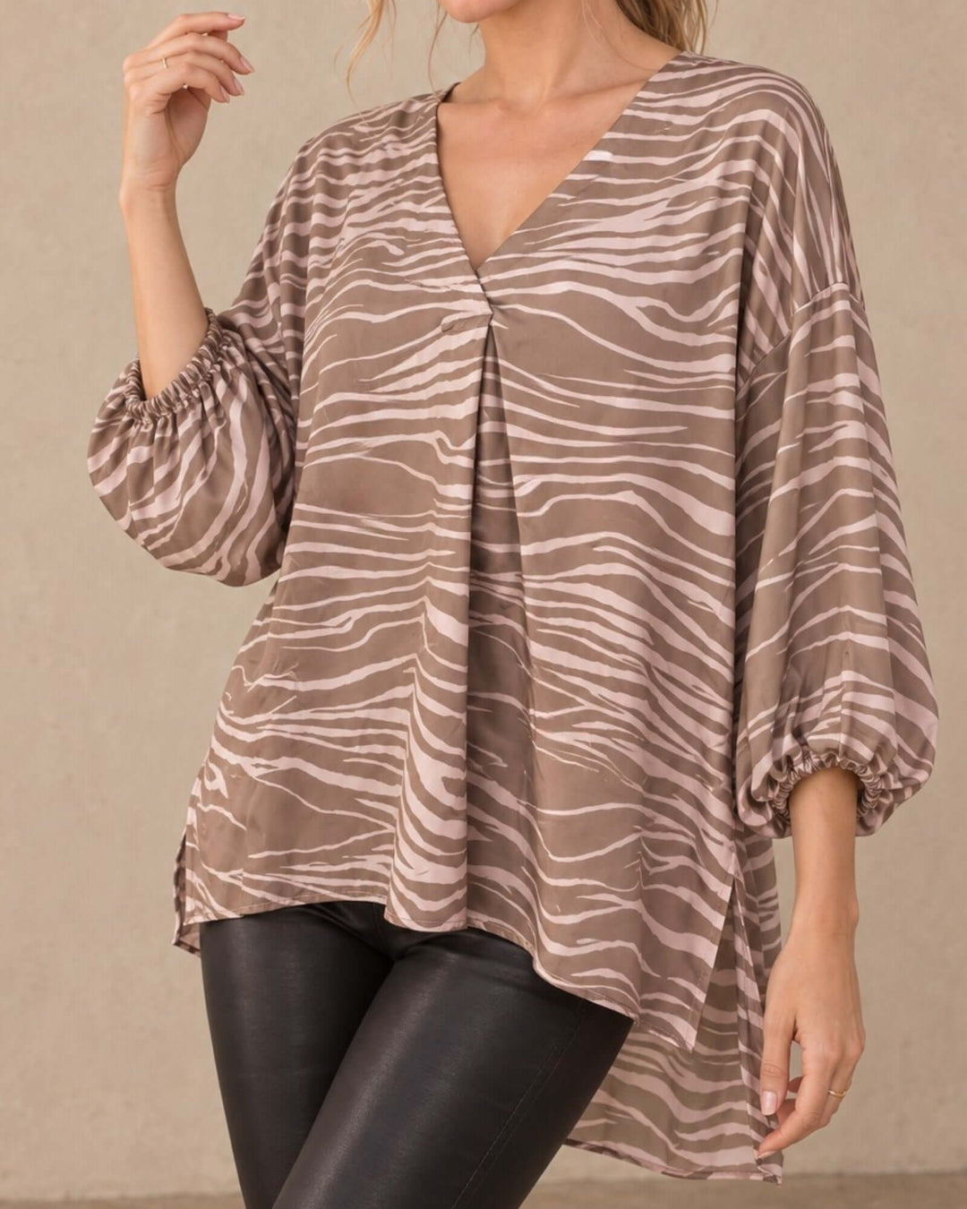 Made in USA taupe and cream zebra print blouse with V neckline, bubble sleeves, and high-low hem