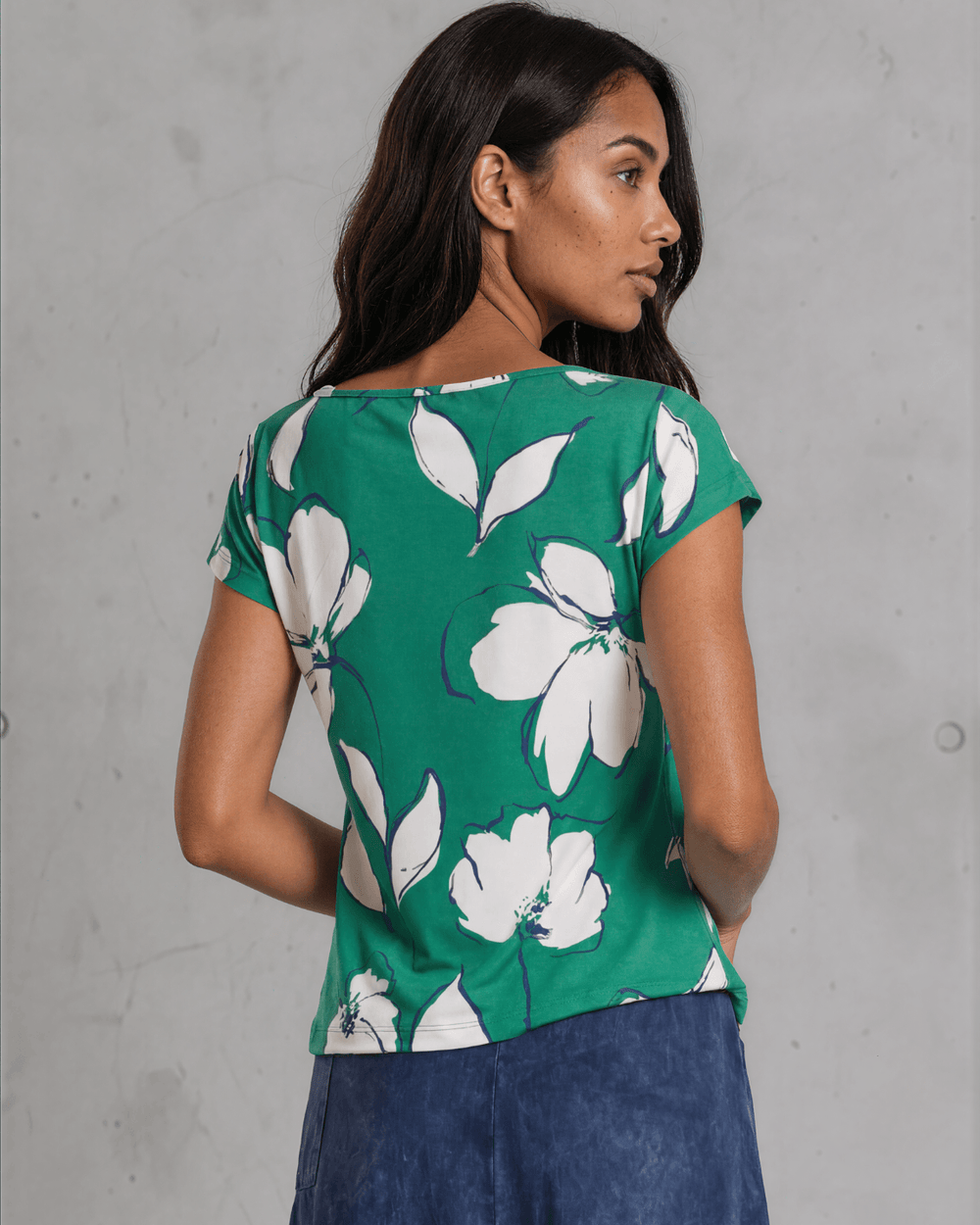 Shop the Farrah Floral Knot Top in bold green & white. Semi-fitted, side knot detail, cap sleeves, sizes S-L. 95% Poly/5% Spandex. Made in USA.