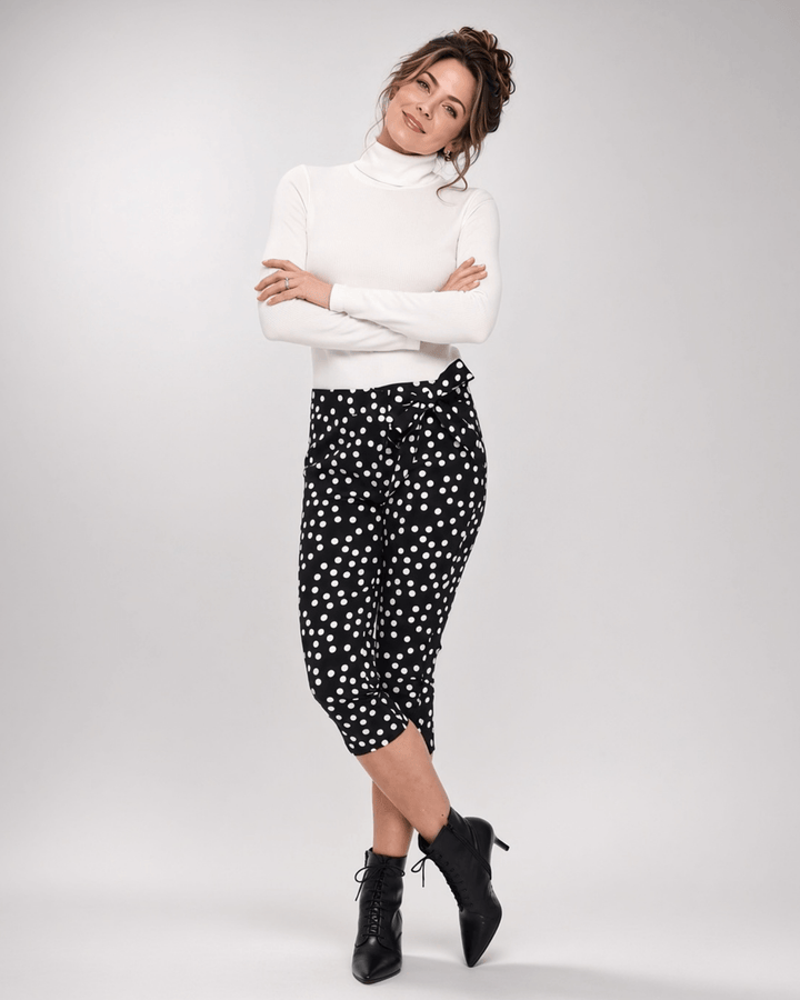 Made in USA. Polly black and white polka dot capri pants feature cotton-rich stretch, a bow waist tie and side-slit hems. A playful statement pair! Style 5460PT by Renee C