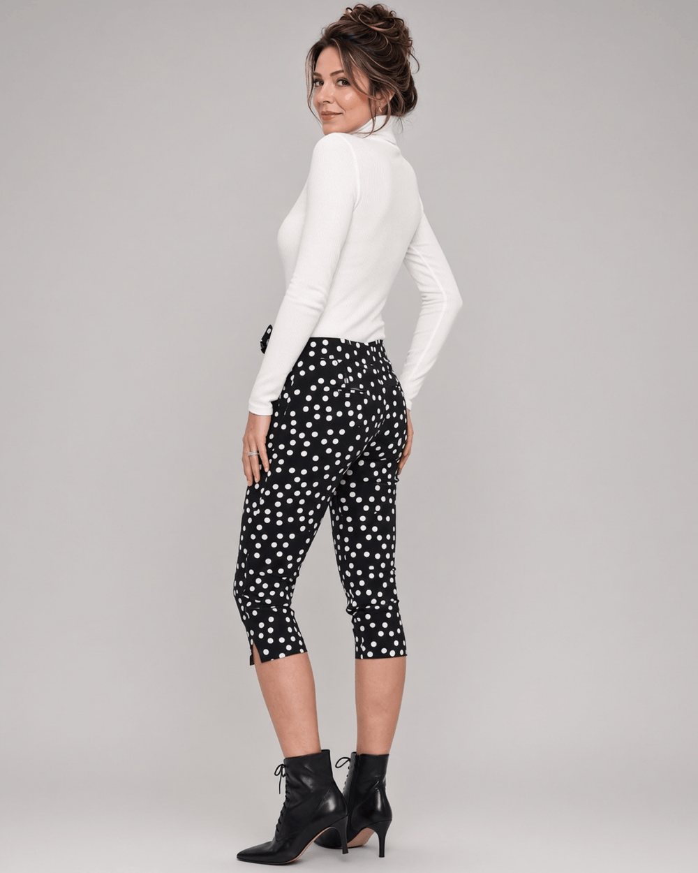 Made in USA. Polly black and white polka dot capri pants feature cotton-rich stretch, a bow waist tie and side-slit hems. A playful statement pair! Style 5460PT by Renee C