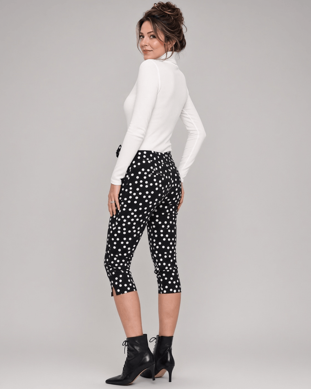 Made in USA. Polly black and white polka dot capri pants feature cotton-rich stretch, a bow waist tie and side-slit hems. A playful statement pair! Style 5460PT by Renee C