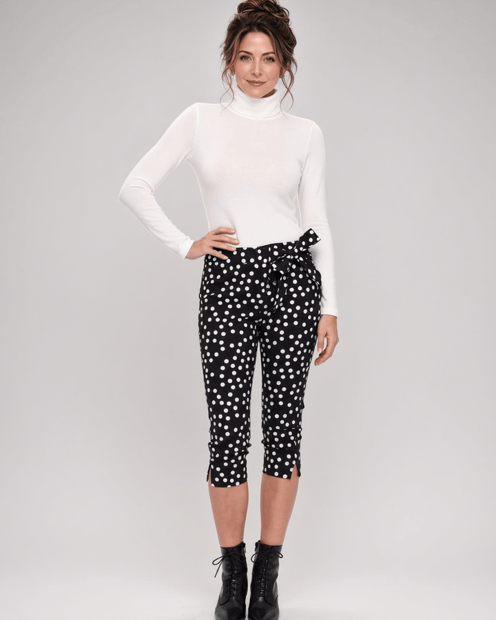 Made in USA. Polly black and white polka dot capri pants feature cotton-rich stretch, a bow waist tie and side-slit hems. A playful statement pair! Style 5460PT by Renee C