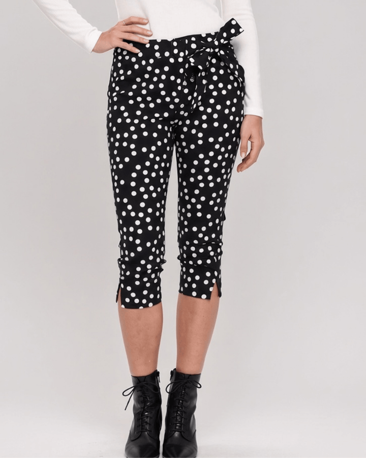 Made in USA. Polly black and white polka dot capri pants feature cotton-rich stretch, a bow waist tie and side-slit hems. A playful statement pair! Style 5460PT by Renee C