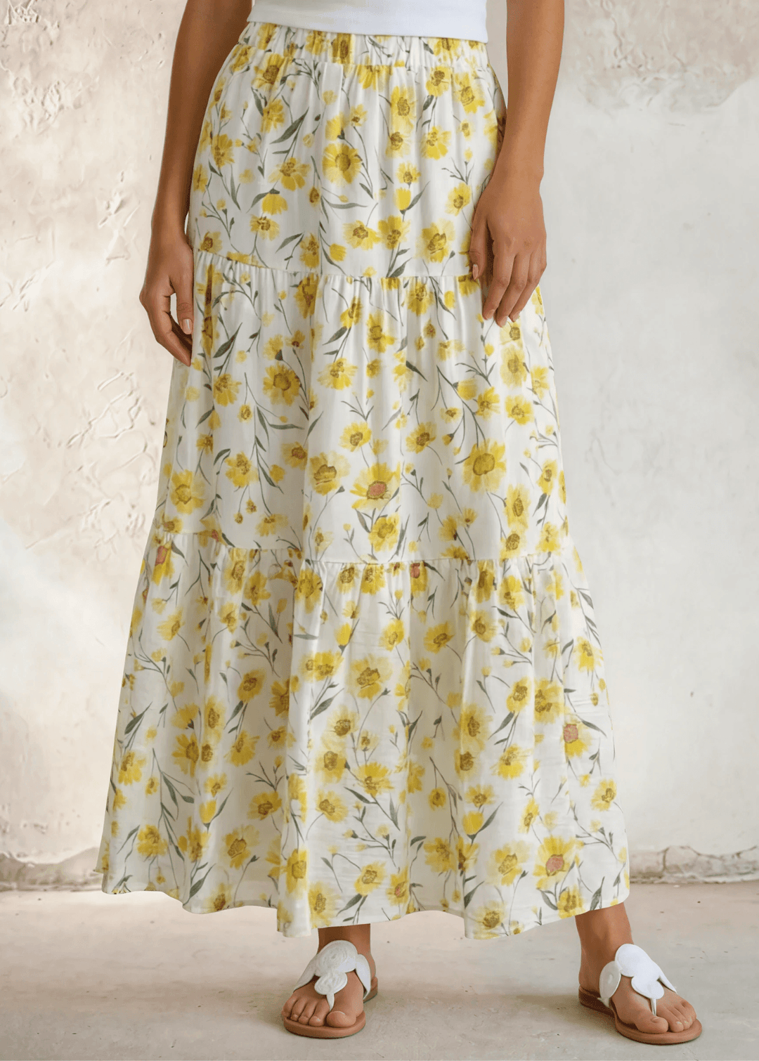 Sunshine meets style — the Sara Sunflower Bloom Maxi Skirt features a yellow floral print, three flowy tiers, and an elastic waist. Made in USA.
