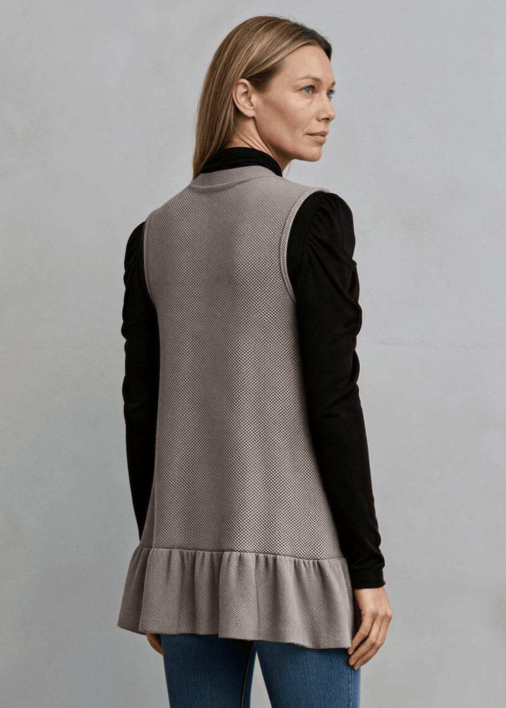 Made in USA, Your go-to layering piece for effortless style. This sleeveless cardigan features a charming flounce ruffle hem that adds movement and dimension to any outfit. 