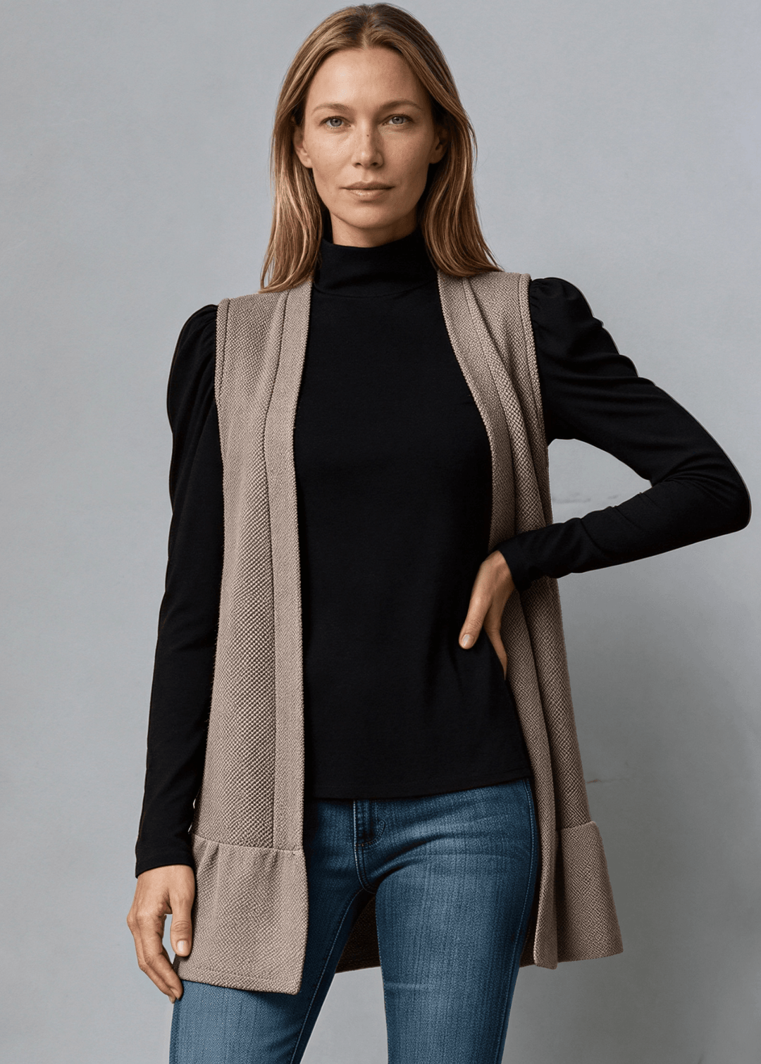 Made in USA, Your go-to layering piece for effortless style. This sleeveless cardigan features a charming flounce ruffle hem that adds movement and dimension to any outfit. 