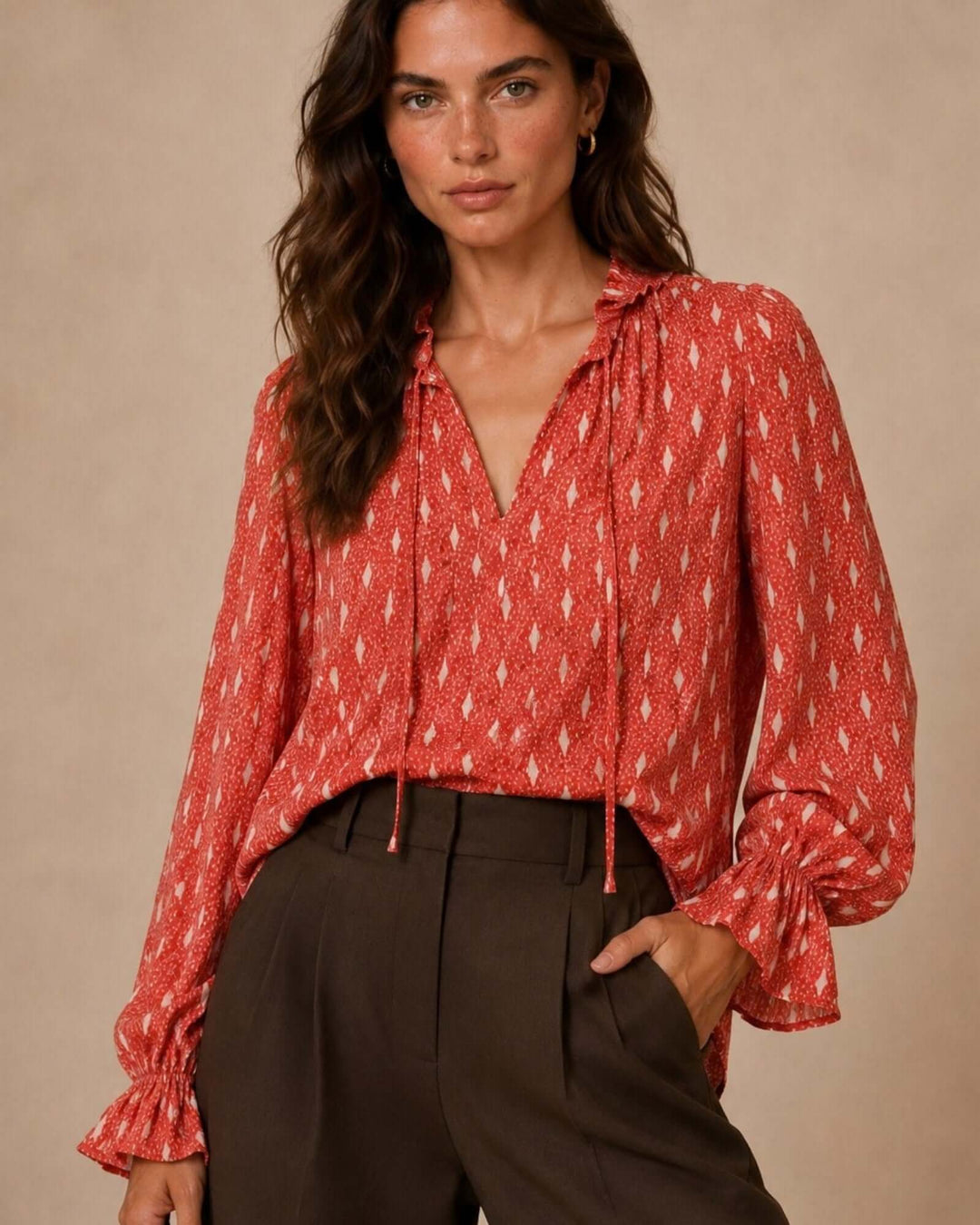 Made in USA Radiant Ruffle Neck Foil Print Blouse - Red: front view tucked into brown pants, tie neck visible
