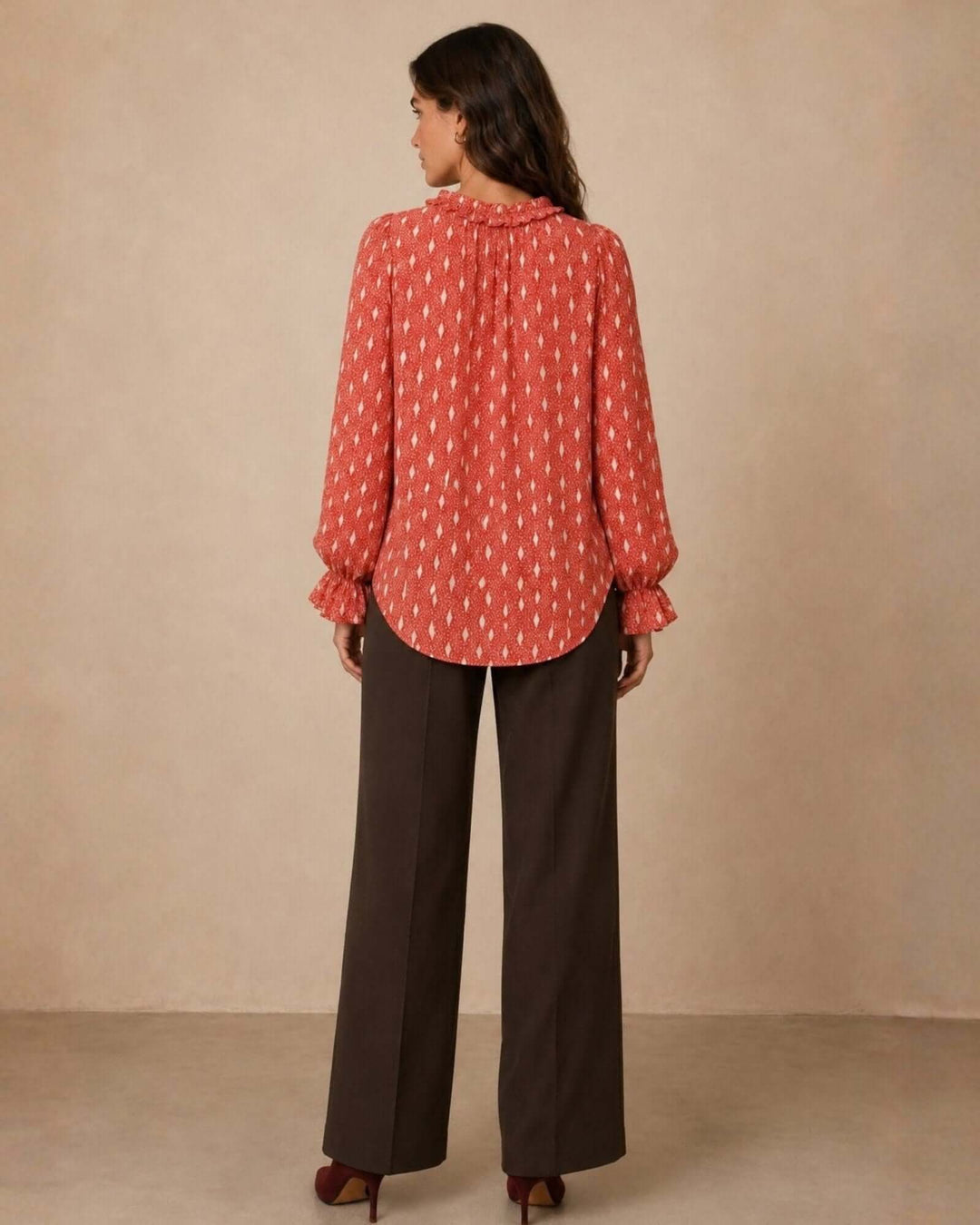 Made in USA Radiant Ruffle Neck Foil Print Blouse - Red: full-length back view with dark brown trousers