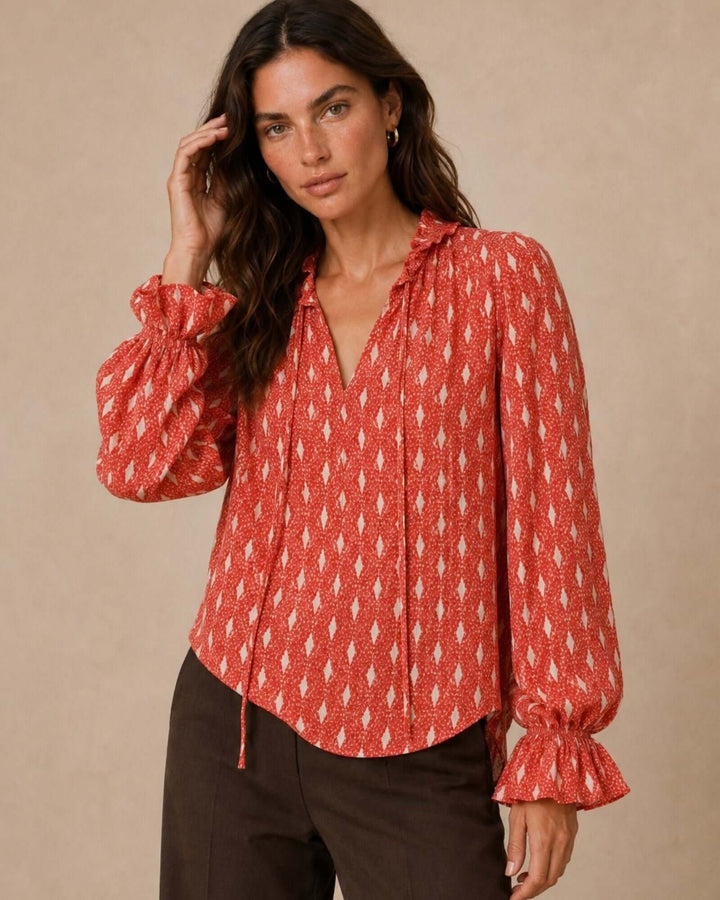 Made in USA Radiant Ruffle Neck Foil Print Blouse - Red: front view with arm raised showing ruffled cuff