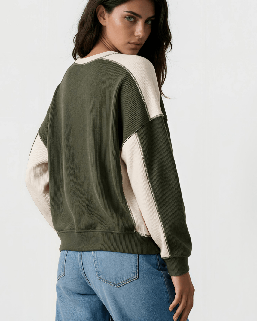 Made in USA. Olive &amp; cream color block ribbed knit sweatshirt. Notched neck, exposed seams, oversized fit. 97% polyester. Sizes S–XL.