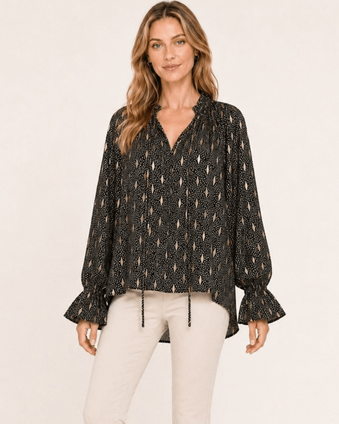 Made in USA Radiant Ruffle Neck Foil Print Blouse - Black: front view tucked at waist with cream pants