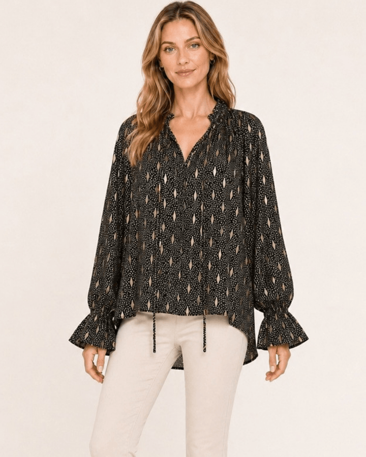 Made in USA Radiant Ruffle Neck Foil Print Blouse - Black: front view tucked at waist with cream pants