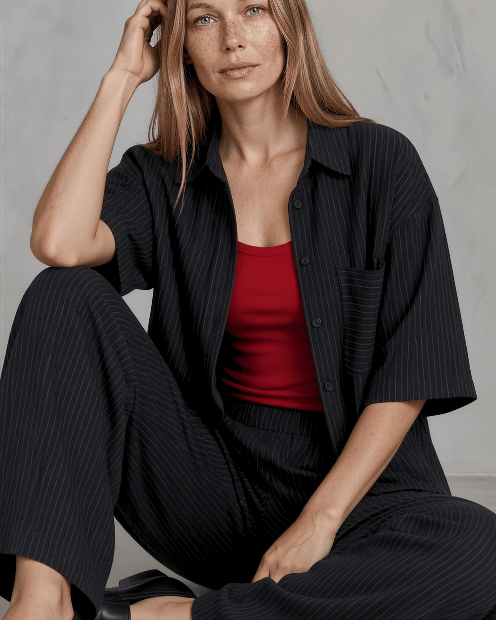 Made in USA Women's Avery high-rise wide leg pinstripe pant in black. Elastic waist, pleated front, full length. 85% rayon, 15% linen. 