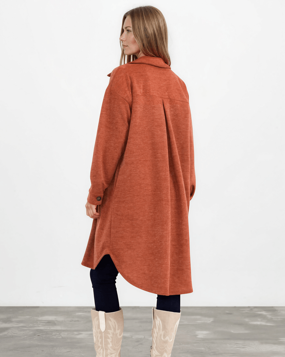 Made in USA. Layer the women's Linden longline shacket in Rust. Relaxed button-down style with soft feel, side pockets and a high-low hem.