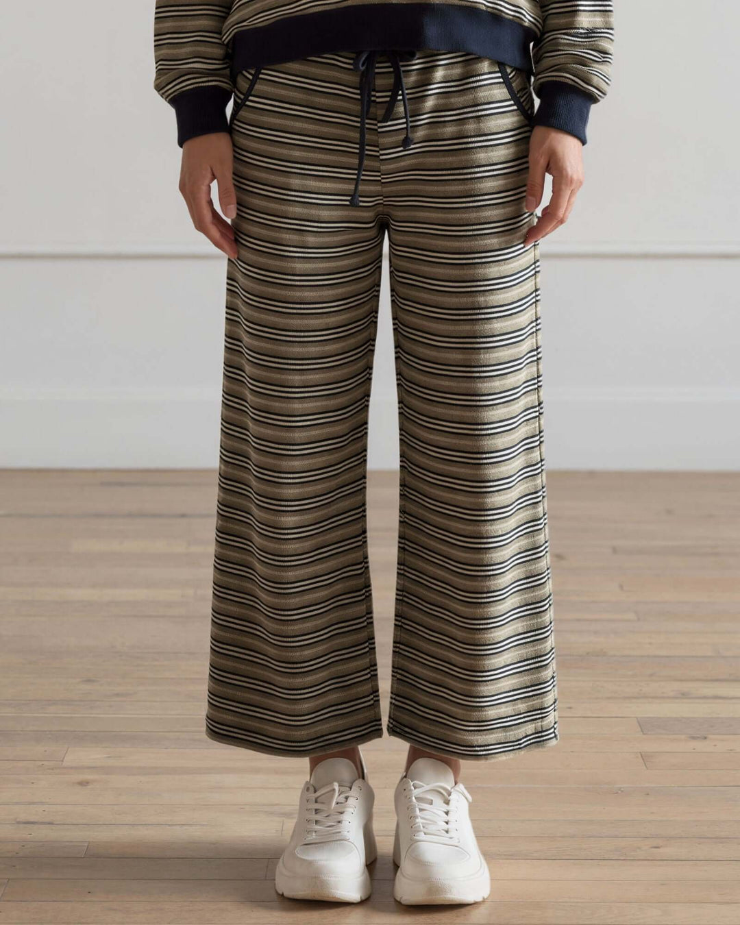 Made in USA women's olive and navy striped wide leg ankle length drawstring lounge pants with side pockets, front view styled with matching striped top