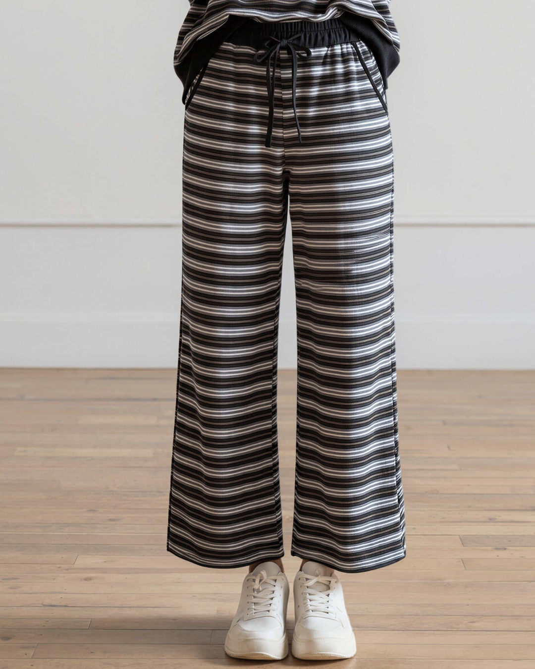 Made in USA women's black and gray striped wide leg ankle length drawstring lounge pants with side pockets, close-up of the wide leg