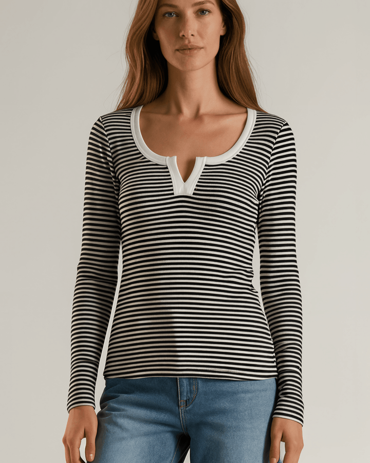 Made in USA. Black &amp; white striped fitted rib knit top. Split V-neck with contrast trim, long sleeves. 97% rayon. Sizes S–XL.
