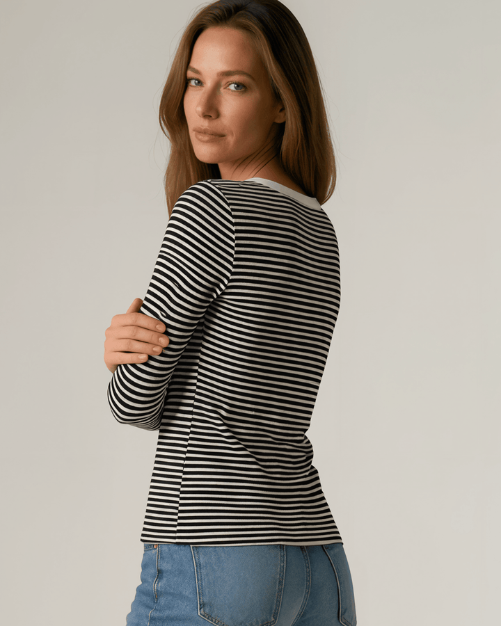 Made in USA. Black &amp; white striped fitted rib knit top. Split V-neck with contrast trim, long sleeves. 97% rayon. Sizes S–XL.