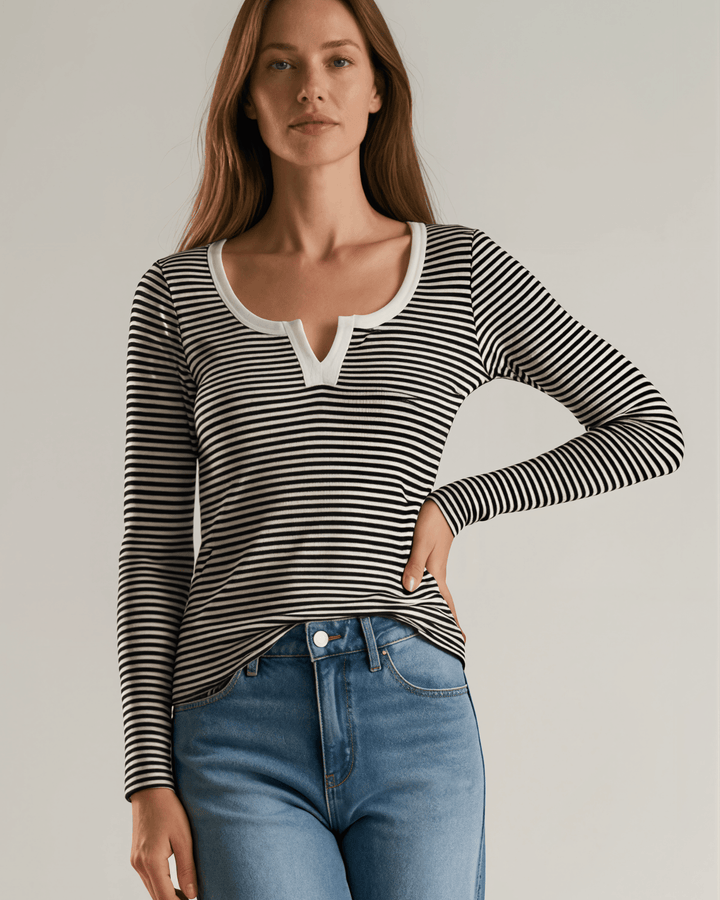 Made in USA. Black &amp; white striped fitted rib knit top. Split V-neck with contrast trim, long sleeves. 97% rayon. Sizes S–XL.