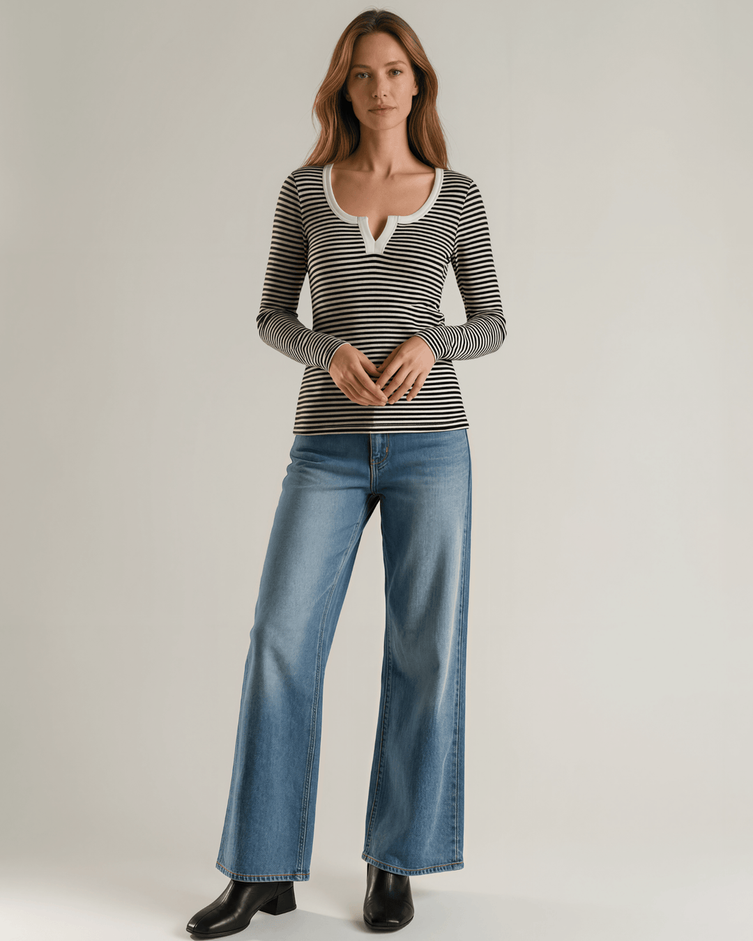 Made in USA. Black &amp; white striped fitted rib knit top. Split V-neck with contrast trim, long sleeves. 97% rayon. Sizes S–XL.
