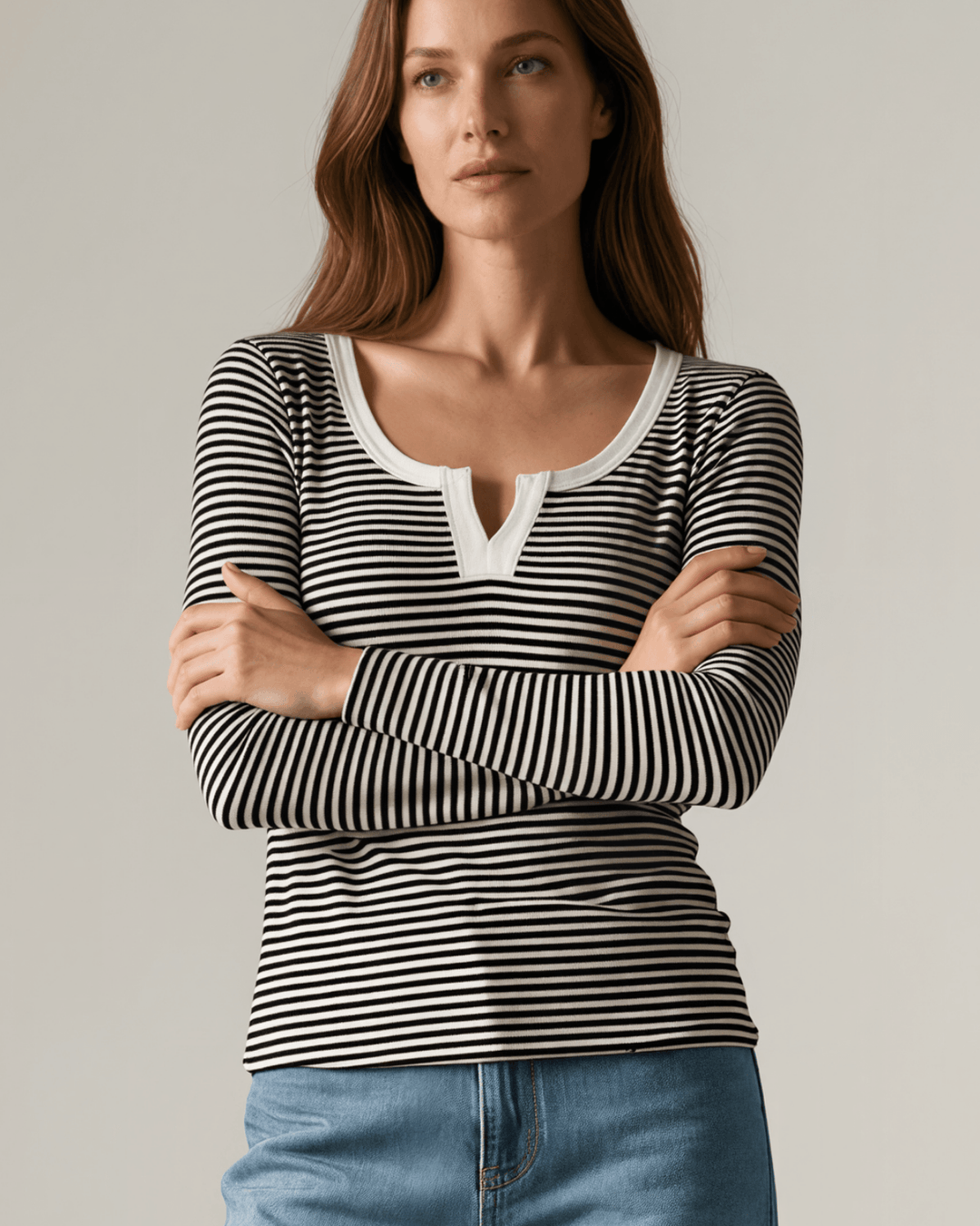 Made in USA. Black &amp; white striped fitted rib knit top. Split V-neck with contrast trim, long sleeves. 97% rayon. Sizes S–XL.
