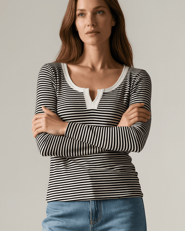 Made in USA. Black &amp; white striped fitted rib knit top. Split V-neck with contrast trim, long sleeves. 97% rayon. Sizes S–XL.